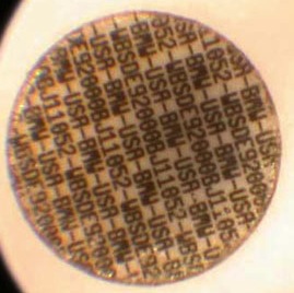 magnified microdot with identifying serial numbers
